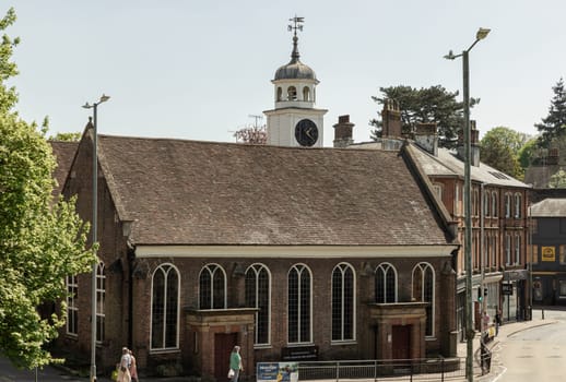 Royal Tunbridge Wells, UK - Apr 29, 2025 - Exterior view of The Church of King Charles the Martyr with was built using red bricks and The spire of clock tower, is a Church of England parish church in Royal Tunbridge Wells, Kent, England. It is a Grade I listed building. use it as your Wallpaper, Poster and Copy space, Selective focus.