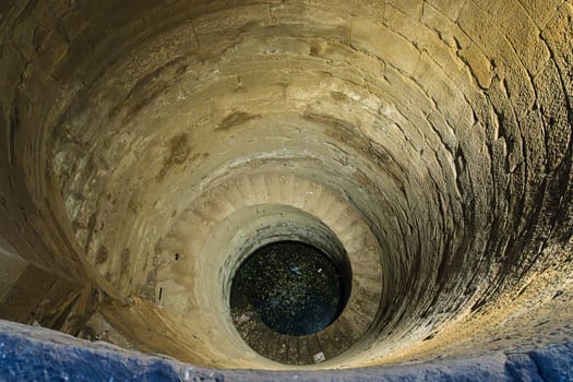 Looking down inside the well at the construction and steps leading to water at Kom Ombo temple in Egypt
