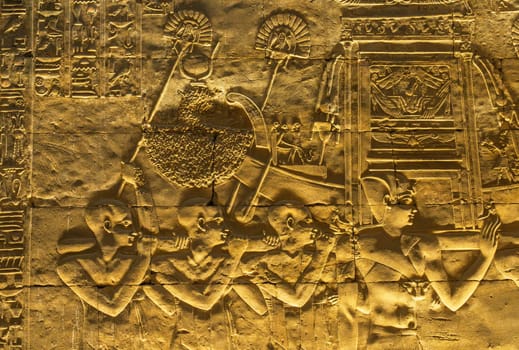 Detail of the carved images inside the temple in Edfu dedicated to Horus and Hathor showing slaves carrying funeral boat