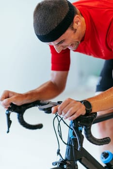 A triathlete riding a triathlon bike on a machine simulation in a modern living room. Training during pandemic conditions