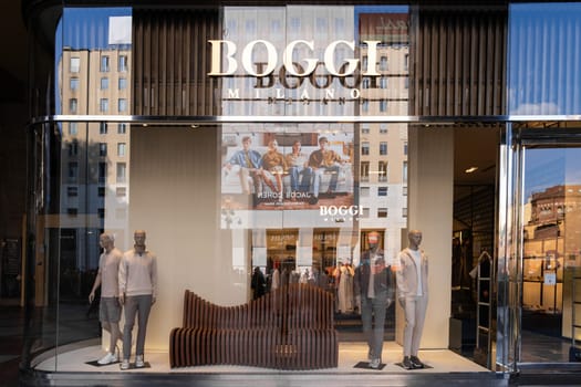Milan, Italy - April, 08, 2025: Boggi Milano store exterior with modern menswear display and mannequins. Fashion storefront in Milan with brand signage, reflection.