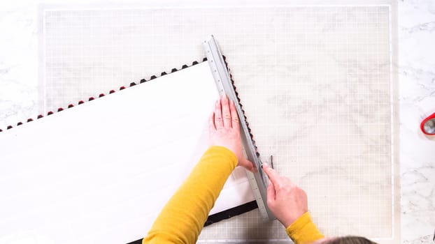 Flat lay. In the process of mounting peel and stick mosaic tiles onto a foam board, perfect for enhancing a food photography studio's aesthetic.
