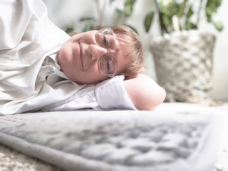 Person lies comfortably on an electric heating pad, surrounded by indoor plants, enjoying a moment of relaxation and warmth.