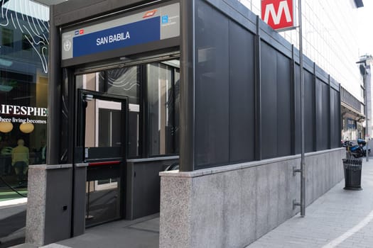 Milan, Italy - April, 08, 2025: San Babila metro station entrance in Milan. Modern structure with signage, red metro logo and pedestrian urban view.