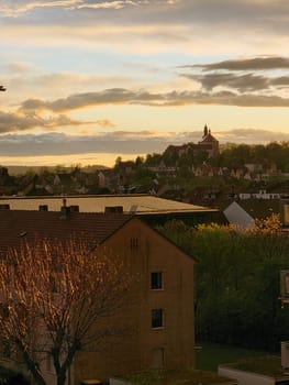 View of Fulda with Frauenberg Monastery during the golden hour at sunset . High quality photo