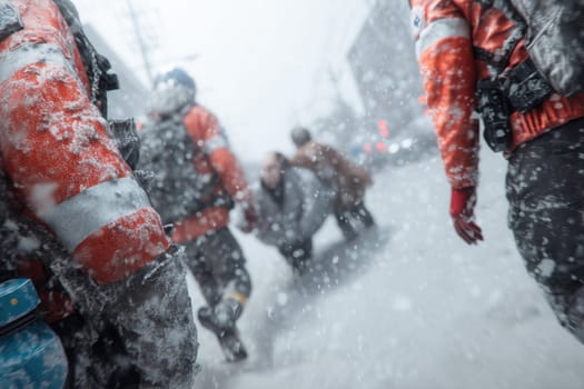 Rescue workers guide civilians through a severe blizzard in an urban environment. Strong image of emergency action, human support, survival, and winter hazards during natural disasters