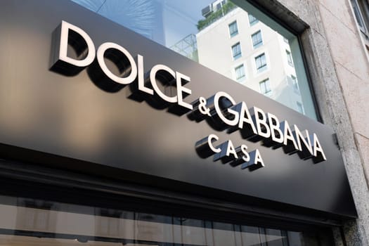 Milan, Italy - April, 08, 2025: Dolce and Gabbana Casa sign on luxury home boutique storefront in Milan. Black facade with white letters, sunny day.