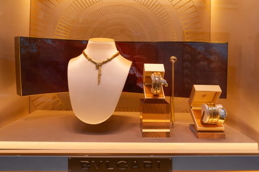 Milan, Italy - April, 08, 2025: BVLGARI jewelry window display. Serpenti necklace, gold bracelets and luxury watch. Milan boutique close-up showcase.