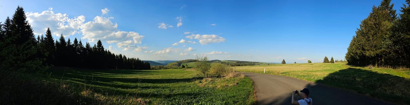 panorama of beautiful countryside of Rhoen, Hesse, Germany. sunny afternoon. wonderful springtime landscape in mountains. grassy field and rolling hills. rural scenery. High quality photo