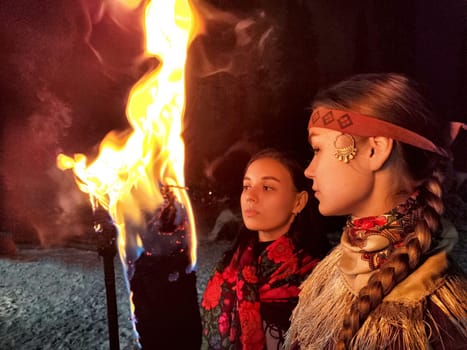 A captivating fire show enhances a winter performance with actors in ethnic costumes, depicting bravery against the cold.