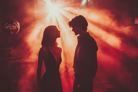 A man and a woman dance side by side in a nightclub, under spotlights and clouds of smoke.