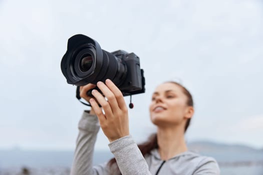 A young woman captures stunning outdoor shots with her professional camera, dressed in sporty attire, radiating enthusiasm and creativity Great for content on photography, lifestyle, and nature