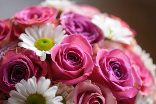 A beautiful arrangement of pink roses and white daisies showcases a vibrant display of colors. This floral bouquet is perfect for celebrations and adds charm to any setting.