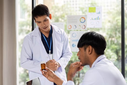 A doctor explaining the details of a prescription medication to a colleague, ensuring clarity in patient treatment.