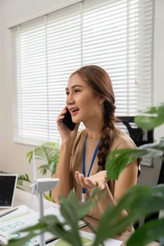 An individual engages in a phone discussion about ESG sustainability concepts, showing enthusiasm for environmental and social responsibility.