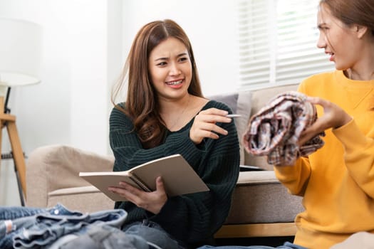Two friends engaged in travel preparation, laughing and discussing as they pack a suitcase in a cozy interior setting, showcasing friendship and excitement.