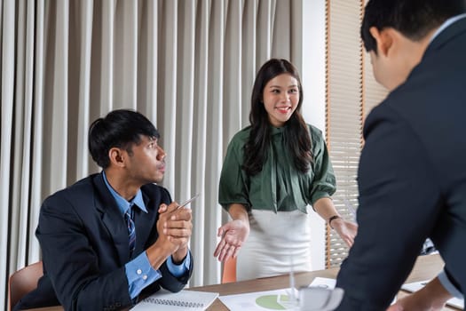 Professionals engaged in discussion during a meeting, focusing on ESG strategies and sustainable practices in a business context.
