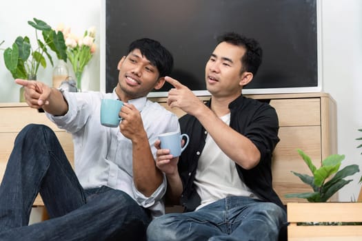 A loving couple enjoys each other's company, sharing laughter and conversation while seated comfortably. Their connection reflects warmth and intimacy, showcasing the beauty of LGBT relationships.