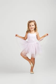 little child girl dreams of becoming a ballerina. ballet dancer in pink tutu