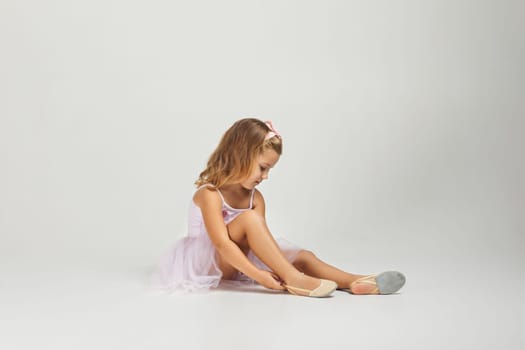 little child girl dreams of becoming a ballerina. ballet dancer in pink tutu
