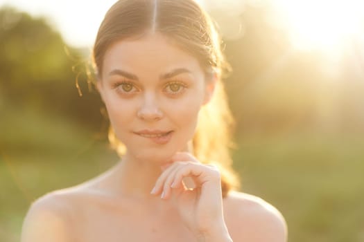A serene young woman with long hair elegantly posing outdoors, radiating warmth in soft sunlight, creating an inviting and peaceful atmosphere