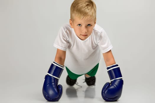 little boxing fighter boy in blue boxer gloves