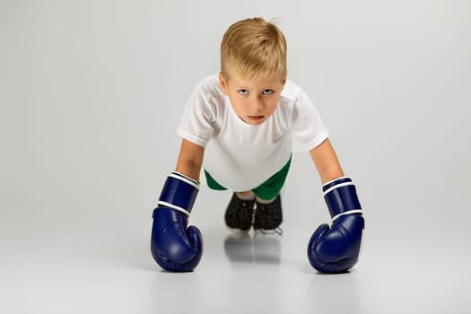 little boxing fighter boy in blue boxer gloves