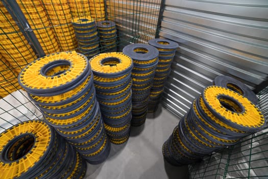 Stacks of screw pile stands in a warehouse, ready for distribution or use in construction projects