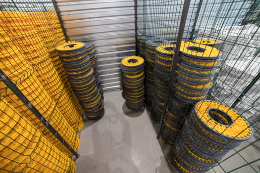 Stacks of plastic drainage cells are stored inside a warehouse, ready for use in construction or landscaping projects