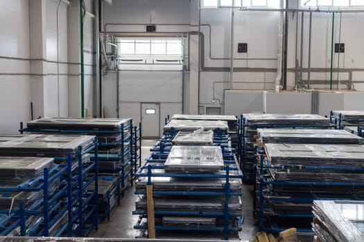 Wrapped pvc window frames are stored and ready for shipping in a large distribution warehouse