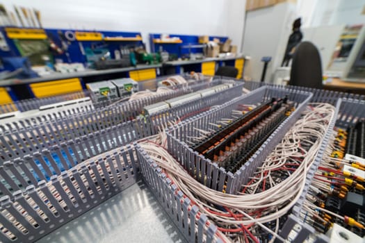 Close-up of an electrical cabinet showing organized wiring and relays, highlighting the complexity of industrial control systems