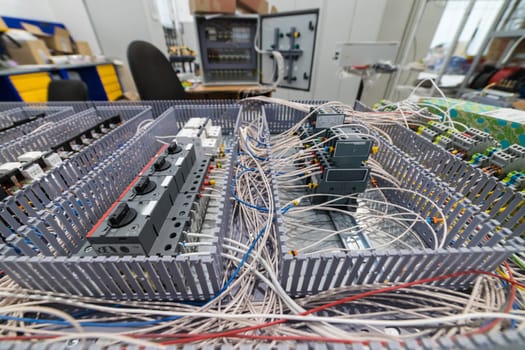 Close-up of an electrical cabinet under assembly, revealing a complex network of wires and circuit breakers
