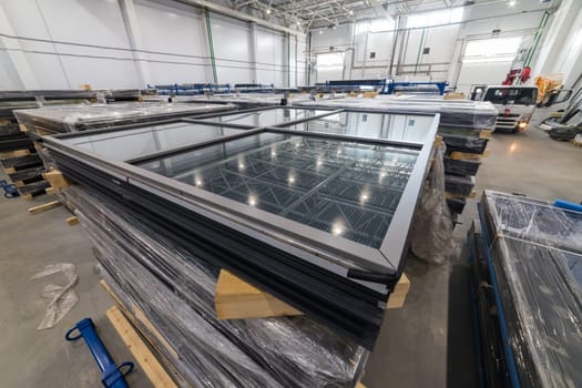 Pvc windows wrapped in stretch film waiting for delivery in distribution warehouse