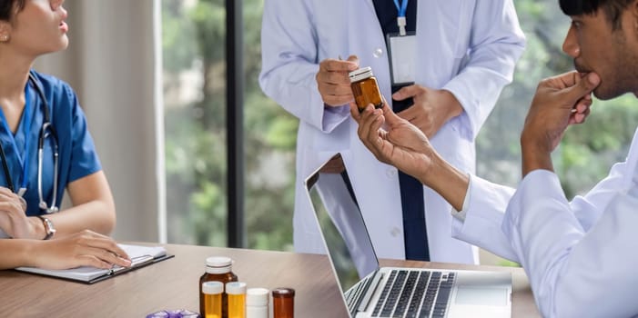 A doctor consulting with a colleague about medication options, fostering communication in a healthcare environment focused on best practices.