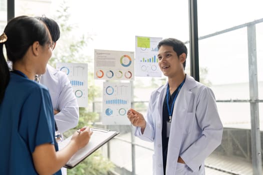 Medical professionals discussing healthcare strategies using data visuals, emphasizing teamwork and effective communication.
