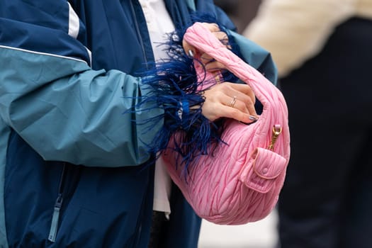 Paris, France - March 11, 2025: Close-up of pink Miu Miu Wander bag with gold hardware and quilted texture, street style outfit details.