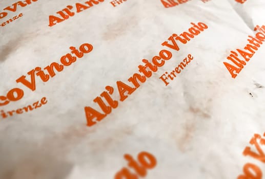 Florence, IT, June 2023: Paper packaging with the logo of All'Antico Vinaio. Renowned sandwich shop located in Florence, Italy. Illustrative editorial. Food and tradition