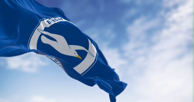 Brighton, UK, May 2023: Brighton and Hove Albion Football Club flag waving in the wind on a clear day. English Premier League team. Illustrative editorial 3d illustration render. Selective focus