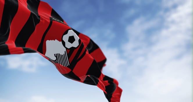 Bournemouth, UK, Oct. 2022: AFC Bournemouth flag waving. English football club based in Kings Park, Boscombe. Illustrative editorial 3d illustration render. Selective focus