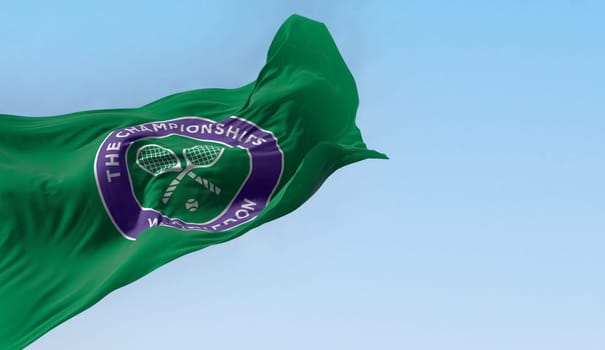 London, UK, May 2023: Flag with The Championships Wimbledon logo waving in the wind. Wimbledon Championships is a major tennis tournament. Illustrative editorial 3d illustration render.