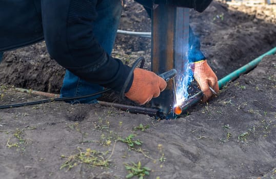 A man doing welding work. Selective focus. People.
