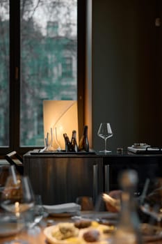 Several bottles of champagne are cooled in a niche with ice in the restaurant, local lighting, wine cabinet, decanters for sparkling wine. High quality photo