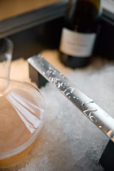 Russia, St.Petersburg, 29 April 2025: Several bottles of champagne brand Bonnet-Ponson are cooled in a niche with ice in the restaurant, local lighting, wine cabinet, decanters for sparkling wine. High quality photo