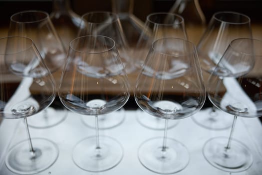 Clean wine glasses are on the table of a special wine cabinet, stylish table setting, ice, bottle of sparkling wine, light from window, decanter and degasser. High quality photo