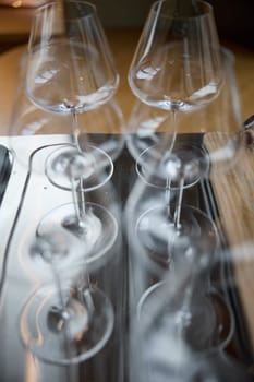 Clean wine glasses are on the table of a special wine cabinet, stylish table setting, ice, bottle of sparkling wine, light from window, decoder and degasser. High quality photo