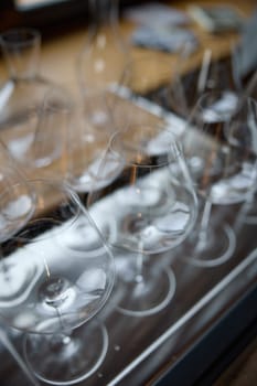 Clean wine glasses are on the table of a special wine cabinet, stylish table setting, ice, bottle of sparkling wine, light from window, decanter and degasser. High quality photo