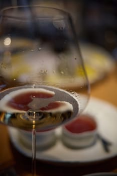 A glass of sparkling wine in close-up, Champagne tasting, Wine glasses are on the table, stylish table setting, sparkling wine bubbles, oysters and sea urchins, special sauce. High quality photo