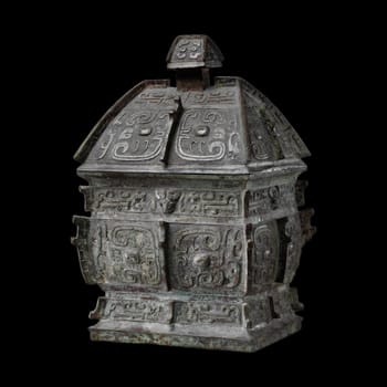 Mid-10th century BCE Chinese bronze rectangular wine container fangyi from the Shang Dynasty. Features intricate taotie masks and geometric patterns. Represents ancient Chinese rituals and bronze artistry.