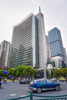 Shanghai, China – 1 April 2025: modern office building of ICBC Bank at busy downtown intersection with car, bicycle, and pedestrian on the street, surrounded by high-rise architecture