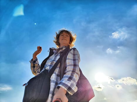 Blonde woman captures a selfie while exploring outdoors, enjoying her travel adventure under a sunny sky.